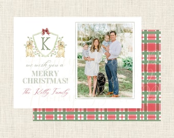 May include: Christmas card featuring a family photograph and a decorative crest with the letter "K", two dogs, and a red bow. The card includes the text "we wish you a MERRY CHRISTMAS! The Kelly Family". The background has a plaid pattern.