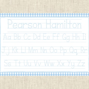 May include: A blue and white gingham border surrounds a white sheet of paper with the name "Pearson Hamilton" at the top. The alphabet is written in dotted lines for tracing practice.