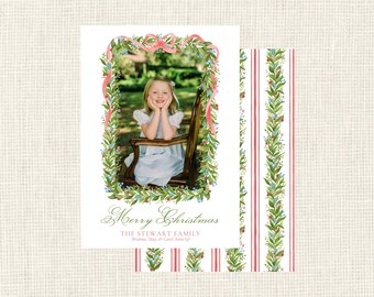 May include: A Christmas card with a photograph framed by a watercolour floral garland and a pink ribbon. The card includes the text "Merry Christmas" and family names. The reverse side has a red and white striped pattern with a floral border.