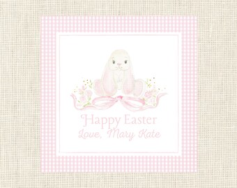 May include: A pink and white gingham border surrounds a white card with a watercolor illustration of a white bunny with pink ears and a pink bow. The text "Happy Easter Love, Mary Kate" is written in pink below the bunny.