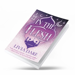 May include: A hardcover book titled "In The Flesh" by Livia Dare. The cover features a purple and white design with a mosque silhouette, crescent moons, and stars. The book has a white background and includes a quote from Shayla Black.