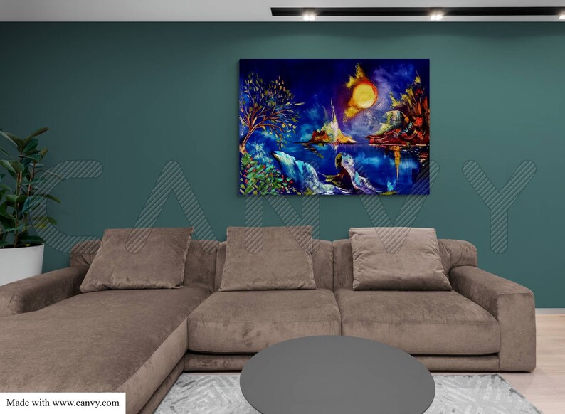 May include: An abstract landscape painting with a vibrant color palette of blues, yellows, and greens. The artwork depicts a moonlit scene with a body of water, trees, and mountains. The painting hangs above a brown sectional sofa.