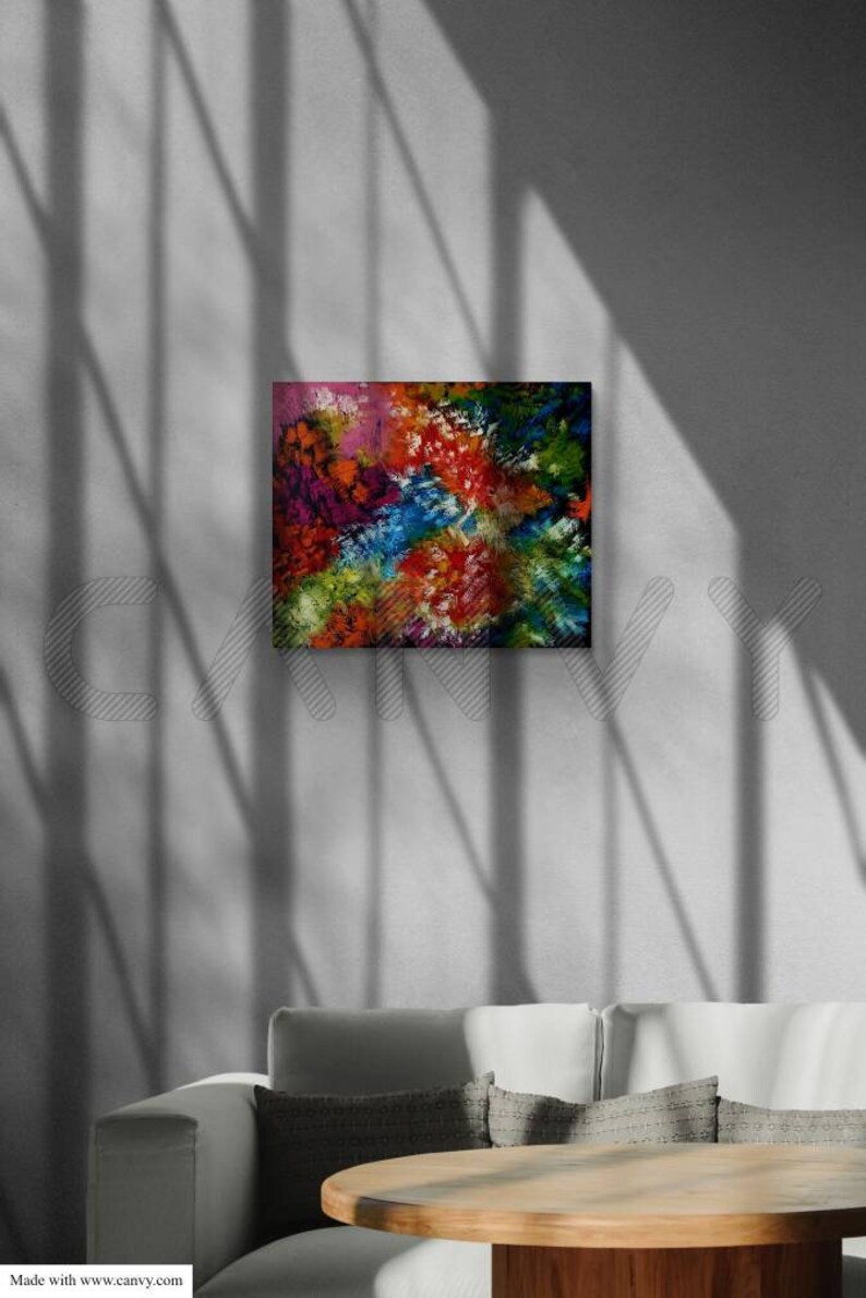 May include: Abstract art painting with a vibrant mix of colors including red, blue, green, and purple. The artwork is displayed on a wall above a sofa and a wooden table. The painting's texture and brushstrokes are visible.