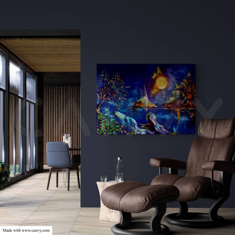 May include: An abstract landscape painting with a vibrant color palette of blues, greens, and yellows. The artwork depicts a surreal scene with a large, bright sun and reflective water. The painting hangs on a dark blue wall above a brown leather recliner.