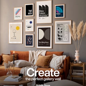 May include: A living room interior design featuring a brown velvet sofa with pillows and a throw blanket. The wall behind the sofa is decorated with a gallery wall of framed prints with geometric designs and text, including "Bauhaus Archiv", "Helvetica", "The Killing Moon", "Relax", and "Charles & Ray Eames". A vase with dried pampas grass is on a side table.