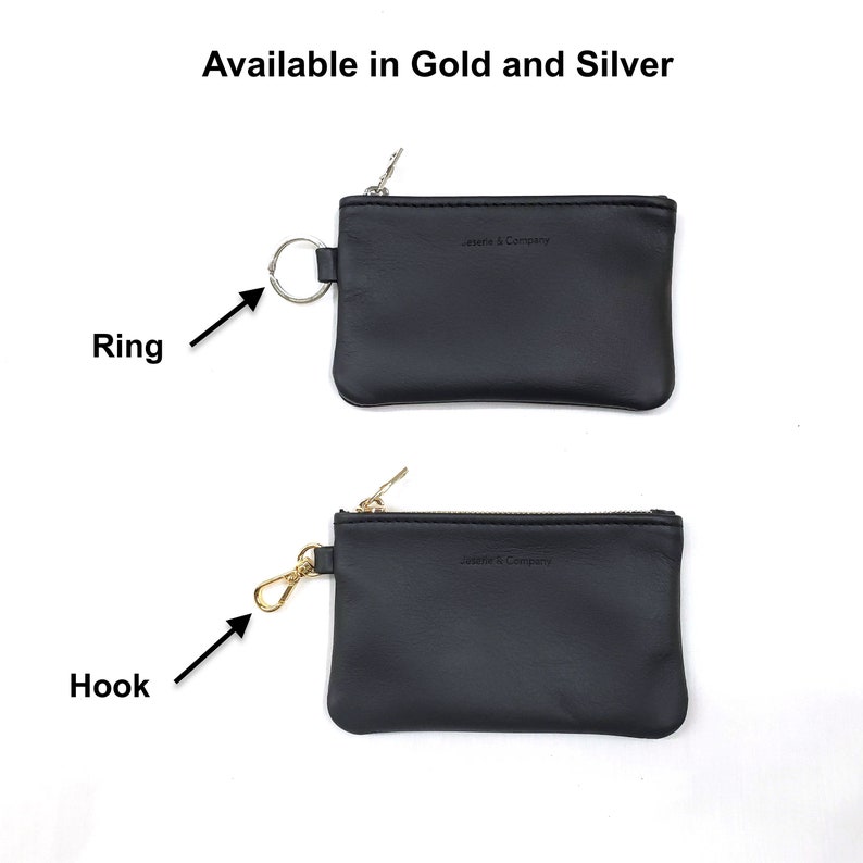 May include: Two black leather coin purses with zippers. The top purse has a silver ring attached to the zipper. The bottom purse has a gold hook attached to the zipper. Both purses have the text "Jessie & Company" embossed on the front.
