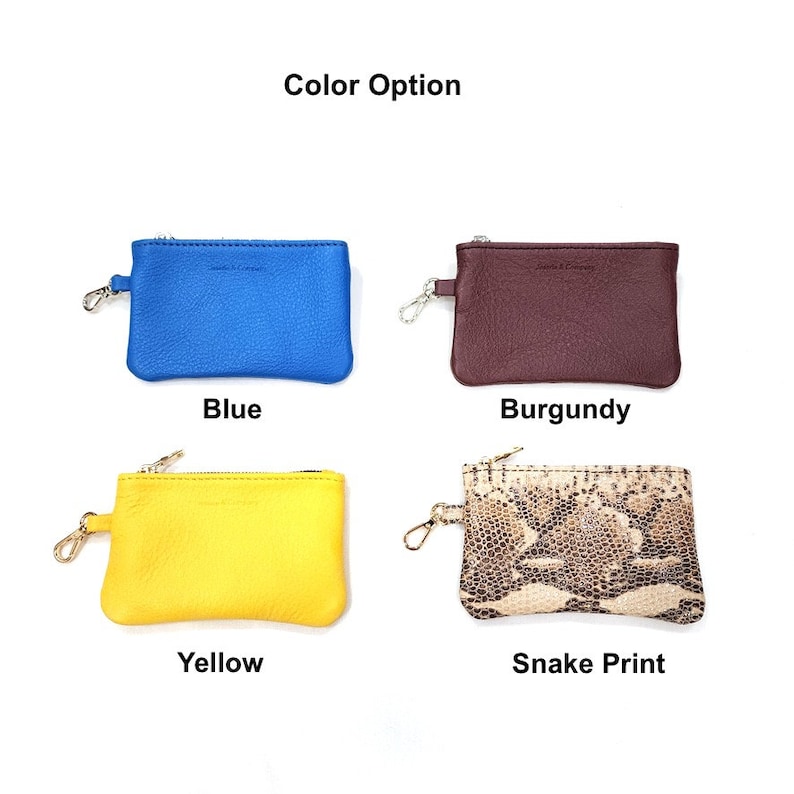 May include: Four small leather coin purses with zipper closures and a metal ring. The purses are in blue, burgundy, yellow, and snake print.