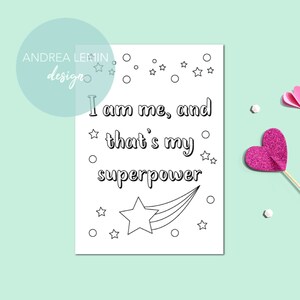 May include: Black and white printable colouring page with the text "I am me, and that's my superpower" and a star with a comet tail.