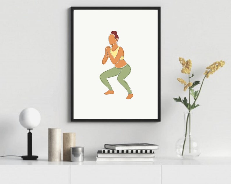 May include: Line art illustration of a person in a yellow sports bra and green pants doing a squat exercise. The illustration is in a black frame and is on a white wall.