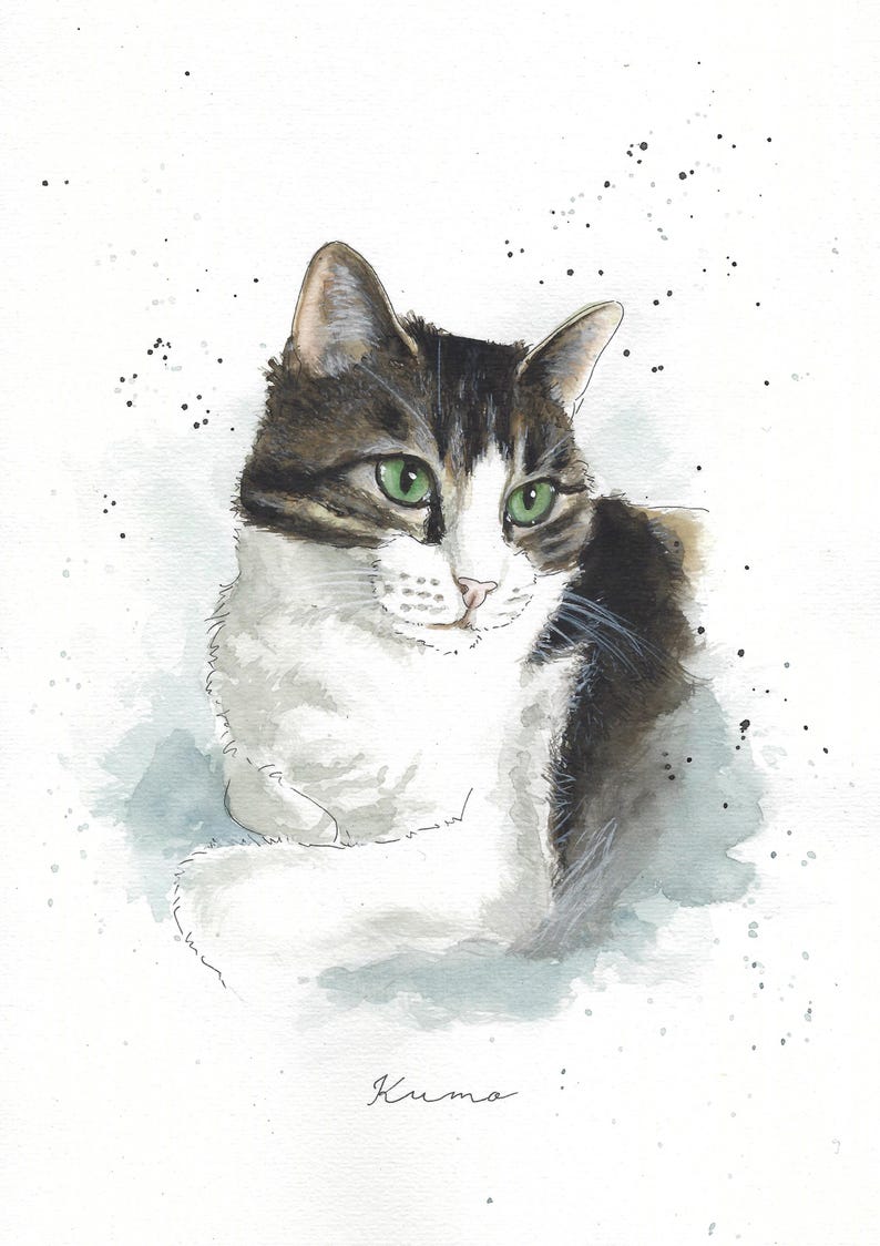 May include: Watercolor painting of a tabby cat with green eyes. The cat is lying down with its head turned to the side. The background is a light blue watercolor wash with white speckles. The cat's name, "Kuma", is written in cursive at the bottom of the painting.