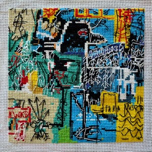 May include: A colorful, abstract needlepoint artwork with a patchwork design. The piece features a black, stylized figure with a red eye, and the text "PARA MORIR". The background includes shades of blue, yellow, and green, with black and white line art.