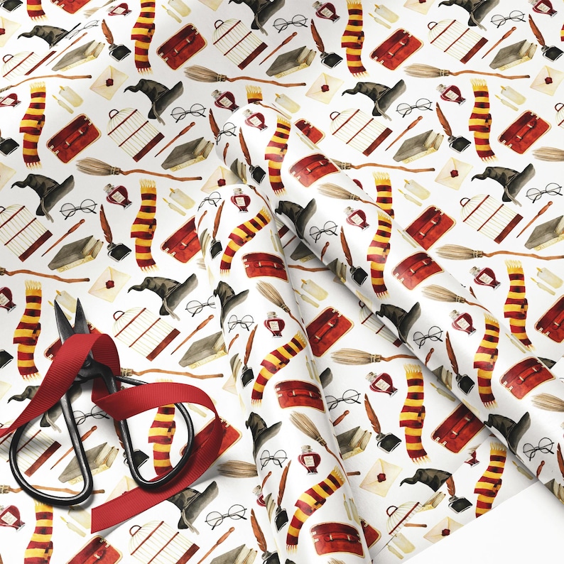 May include: White wrapping paper with a repeating pattern of wizarding school-themed illustrations. The design includes scarves, books, eyeglasses, quills, hats, and other magical elements. A pair of scissors with a red ribbon is in the lower left corner.