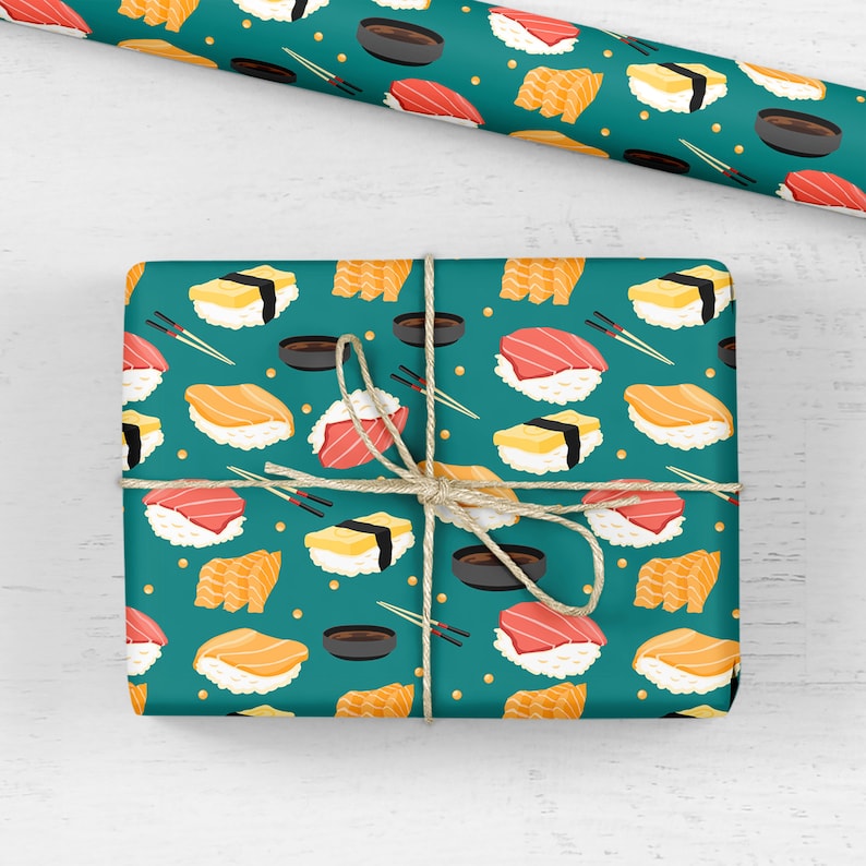 May include: Teal blue wrapping paper with a repeating pattern of sushi rolls, soy sauce dishes, and chopsticks. The sushi rolls are filled with salmon, tuna, and egg.