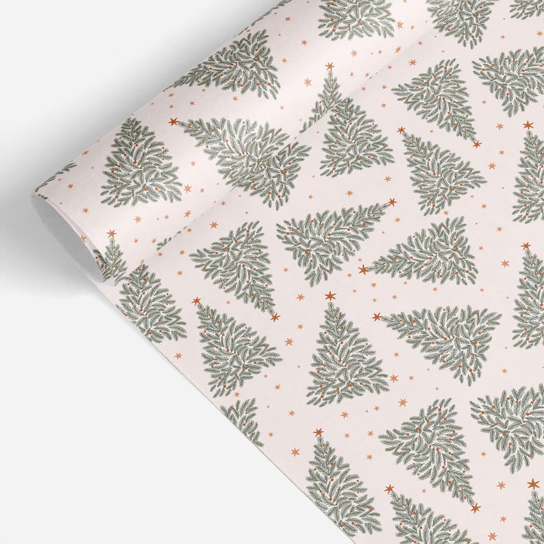 May include: A roll of wrapping paper featuring a repeating pattern of stylized evergreen trees in shades of sage green and dark green on a pale pink background, accented with small orange stars scattered throughout the design.