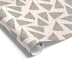 May include: A roll of wrapping paper featuring a repeating pattern of green pine trees on a light pink background. The design includes small orange stars scattered between the trees, creating a festive look across the entire surface of the paper.