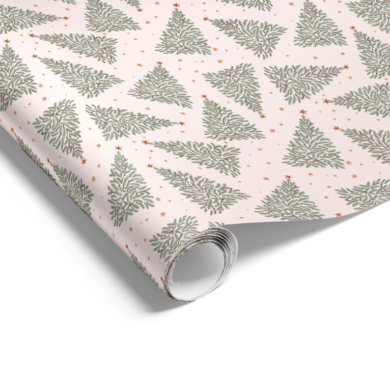 May include: A roll of wrapping paper featuring a repeating pattern of green pine trees on a light pink background. The design includes small orange stars scattered between the trees, creating a festive look across the entire surface of the paper.