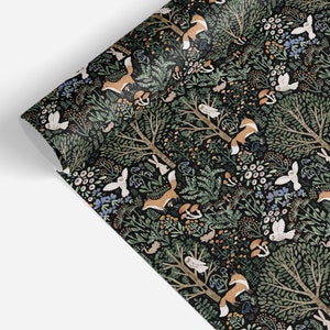 May include: A roll of wrapping paper featuring a dark black background with a repeating pattern of orange foxes, white owls, brown mushrooms, green trees, and various small woodland plants and flowers scattered throughout the forest scene.