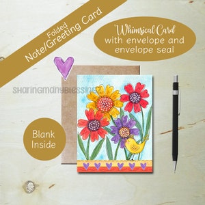 May include: A folded greeting card featuring a watercolor illustration of yellow, red, and purple flowers with a small yellow bird. The card includes a brown envelope, a purple heart sticker, and a black mechanical pencil. Text reads SharingManyBlessings.