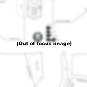 May include: A black and white image of a map with a circle in the center. The circle is blurred and out of focus. The text "(Out of focus image)" is below the circle.