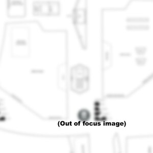 May include: A black and white diagram of a building floor plan with text labels. The diagram is out of focus.