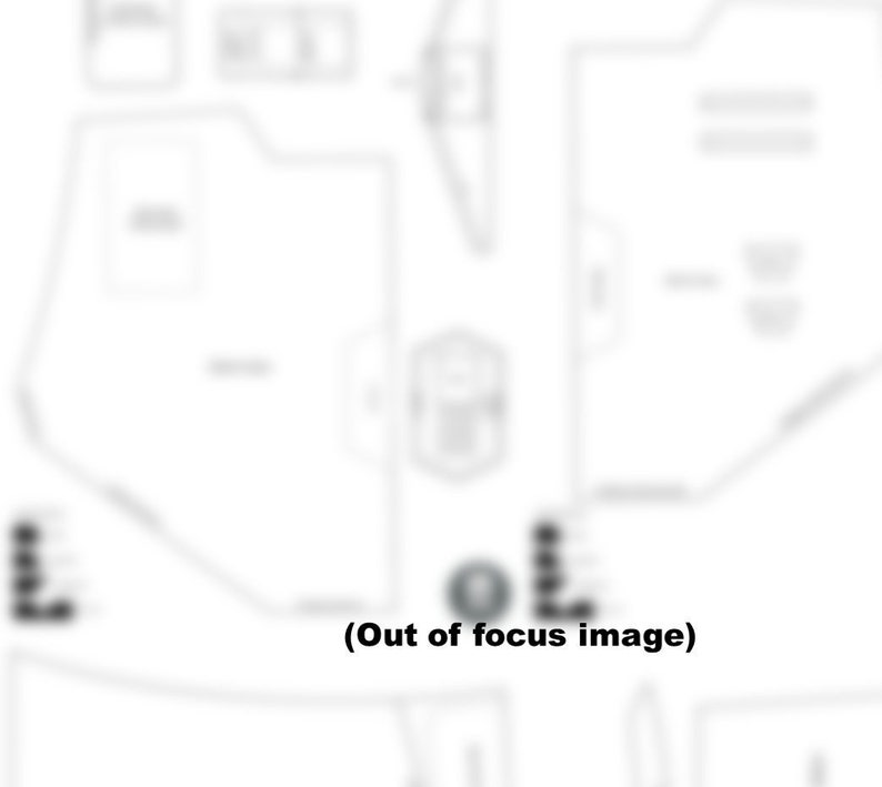 May include: A black and white diagram of a building floor plan with text labels. The diagram is out of focus.