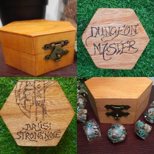 May include: Three wooden boxes with engraved designs. The first box is engraved with "Dungeon Master", the second box is engraved with "Brusl Strongnoe", and the third box has a design of a sword and shield. The boxes are all made of light brown wood and have brass hinges.