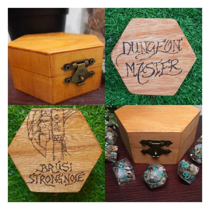 May include: A hexagonal wooden box with a brass clasp, displaying a natural wood grain. The lid is engraved with "DUNGEON MASTER" in a handwritten style. Another lid features an illustration and the name "BR&Uacute;SI STRONGNOSE".
