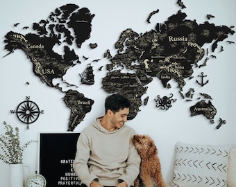 May include: A black and gold wooden world map wall decor with country names. A black compass and decorative elements are also on the white wall. A person is sitting on a wooden bench with a dog.