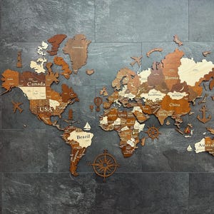 May include: A wooden world map with countries and continents in varying shades of brown and tan. Decorative nautical elements like a compass rose, sailboats, and an anchor are included. The map is mounted on a dark gray tiled surface.