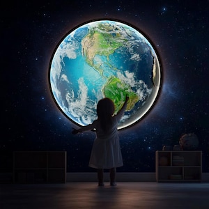 May include: A young person in a white dress reaches out to touch a large, illuminated globe of the Earth, set against a dark blue starry sky.