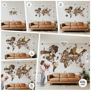 May include: Wooden world map wall art in various sizes, from XS to XXL. The maps are made of different shades of brown wood and include country outlines, compasses, and anchors. The maps are displayed above brown sofas.