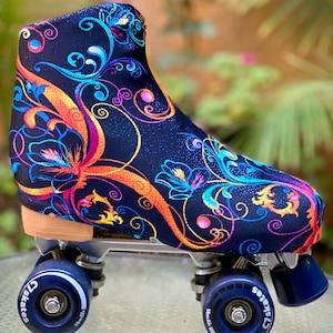 May include: A pair of roller skates with a black boot covered in a colorful floral pattern. The boot has a sparkly finish. The wheels are blue with white lettering that says "C2 Skates".