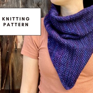 May include: A knitting pattern for a purple and blue triangular scarf. The scarf is shown being worn by a person.