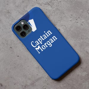 May include: A blue phone case with a white Captain Morgan logo. The case has a cutout for the phone's camera.