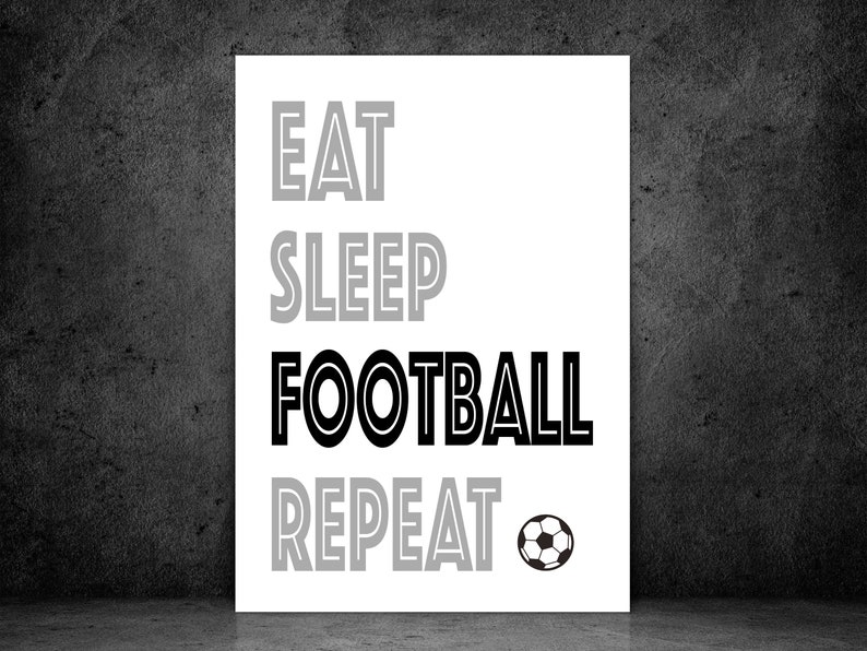 May include: Black and white print with the text "Eat Sleep Football Repeat" and a black and white soccer ball.