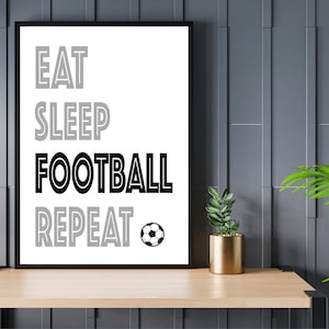 May include: Black and white framed print with the text "Eat Sleep Football Repeat" and a soccer ball graphic.