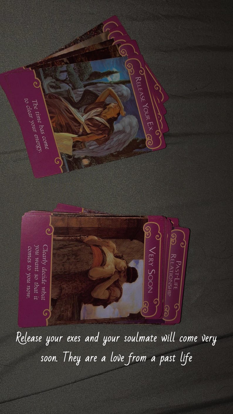 May include: A deck of rectangular oracle cards with magenta borders and gold filigree corners. The cards feature classical illustrations and text including Release Your Ex, Very Soon, and Past-Life Relationship. The text reads: The time has come to clear your energy. Clearly decide what you want so that it comes to you now. Release your exes and your soulmate will come very soon. They are a love from a past life.