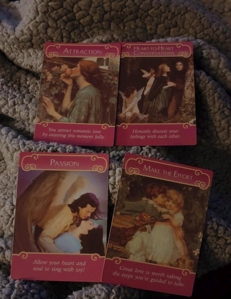 May include: Four rectangular oracle cards with pink borders and romantic illustrations. The cards are titled Attraction, Heart-to-Heart Conversations, Passion, and Make the Effort, each featuring printed text messages at the bottom of the cards.