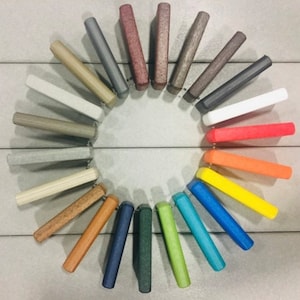 May include: A color chart of 24 different colors, arranged in a circle. The colors range from light gray to dark green, with a variety of shades in between.