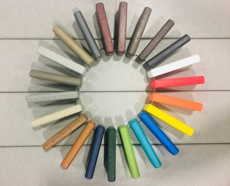 May include: A color chart of 24 different colors, arranged in a circle. The colors range from light gray to dark green, with a variety of shades in between.