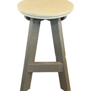 May include: A gray and beige plastic stool with a round seat and a simple A-frame design.