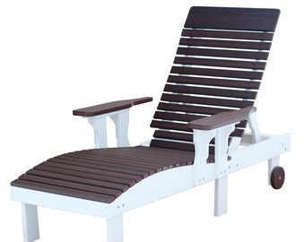 May include: A white and brown outdoor chaise lounge with a slatted back and seat. The chair has armrests and small wheels for easy movement. The frame is white, and the seat and back are brown.