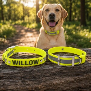 May include: Two neon yellow dog collars featuring a reflective silver center stripe and a silver metal buckle. One collar displays the name WILLOW in bold black letters. The collars are constructed from a smooth, durable material with metal rivets.