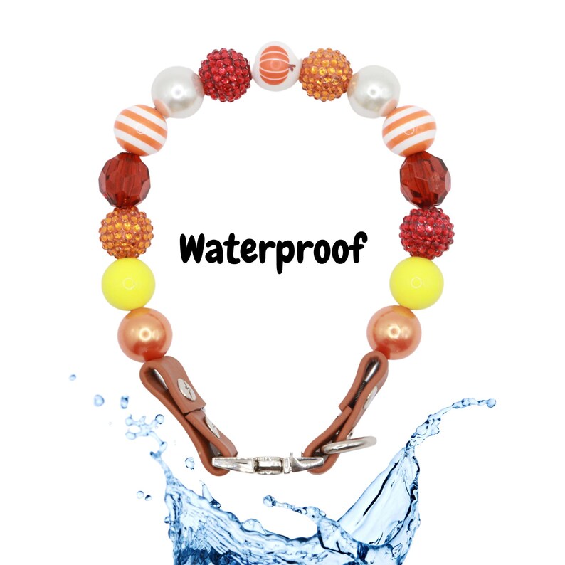 May include: A colorful beaded necklace with a brown leather strap and a metal clasp. The necklace is waterproof and features a variety of colors, including red, orange, yellow, and white. The text "Waterproof" is printed on the image.