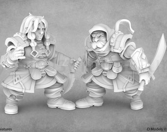 May include: Two miniature figures of fantasy characters, both with beards and wearing hooded cloaks and armor. One figure is holding a dagger, and the other is holding a sword.