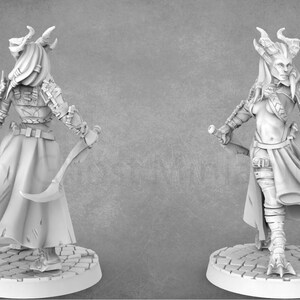 May include: A white painted miniature figurine of a female figure with horns, wearing a long robe and holding a dagger. The figure is standing on a circular base.