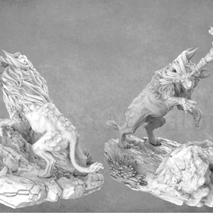 May include: A white 3D printed miniature of a warrior battling a monstrous beast. The warrior is leaping through the air, sword raised, while the beast lunges forward with its claws extended. Both figures are posed on rocky bases.