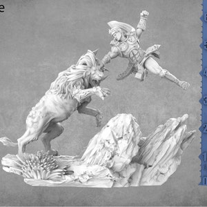 May include: A white miniature figurine of a warrior fighting a wolf-like creature. The miniature is set on a rocky base and is approximately 7.5 cm tall.