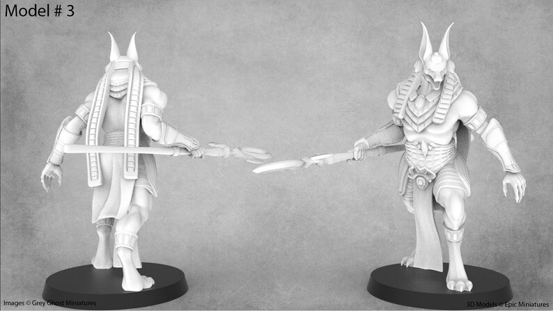 May include: A white plastic miniature figurine of an Egyptian god with a jackal head, wearing a traditional headdress and holding a staff. The figurine is standing on a black base. Model #3.