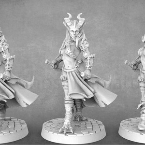 May include: Three miniature figures of female characters in different poses. The figures are wearing armor and carrying weapons. The figures are painted in a gray color.